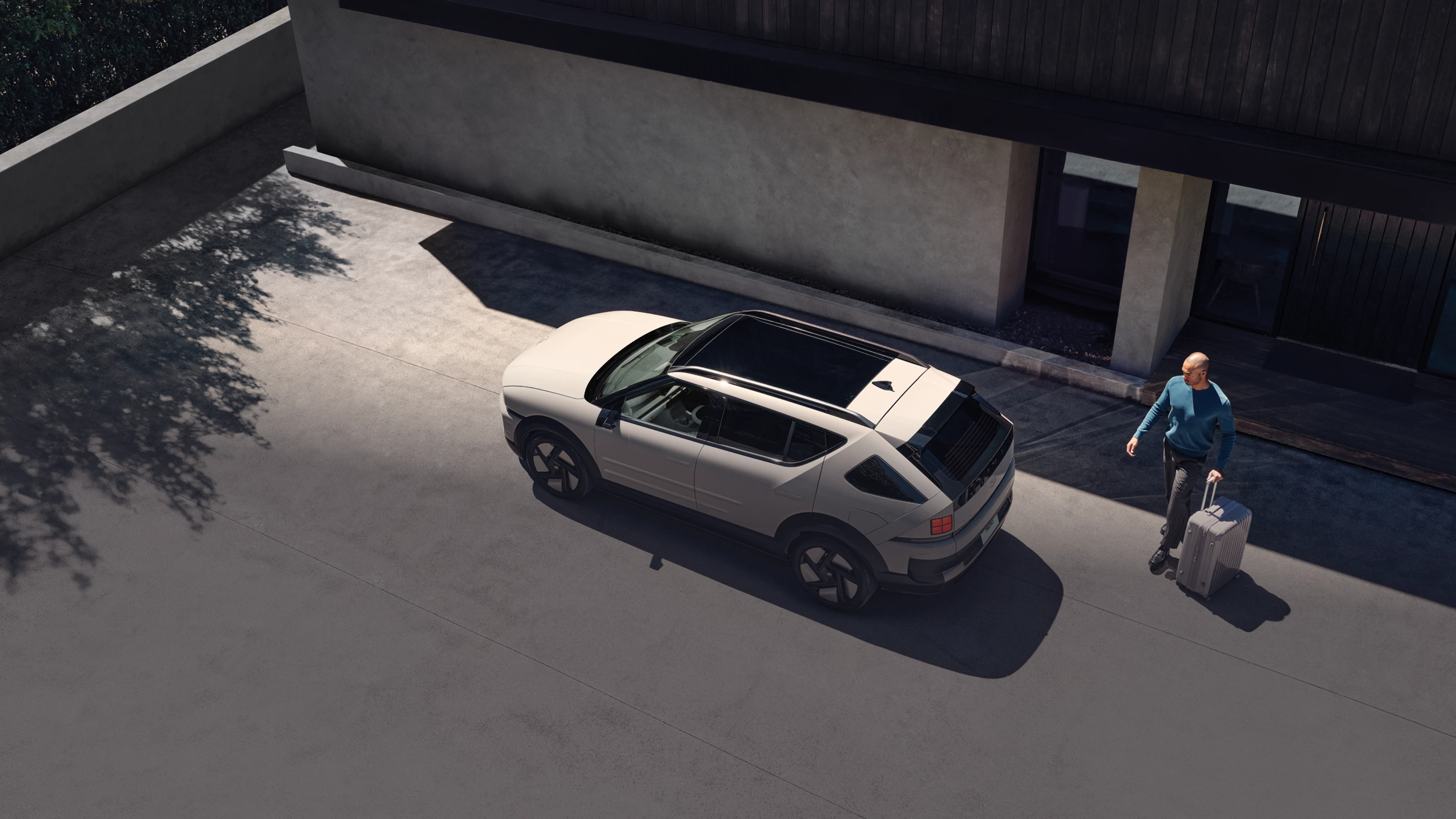 建物の横に駐車されたThe all-new NEXOを上から見下ろしたハイアングルショット - Hyundai Mobility Japan (ヒョンデ ジャパン)